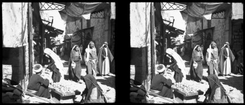 Jerusalem [narrow street with awnings and a food stall] [picture] / [Frank Hurley]
