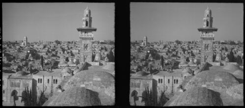 Scenes in Jerusalem, Mosque of Omar on site of King Solomons Temple & etc [minaret of the Dome of the Rock amongst city buildings' rooftops] [picture] / [Frank Hurley]