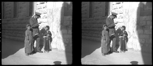 Jerusalem [a man in military uniform with two children in front of a brick building, ca. 1940-1945] [picture] / [Frank Hurley]