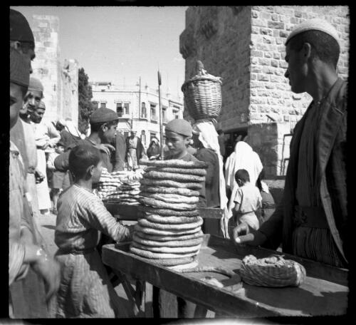 Street scenes in Jerusalem [outdoor market, bakery, bread stall] [picture] / [Frank Hurley]