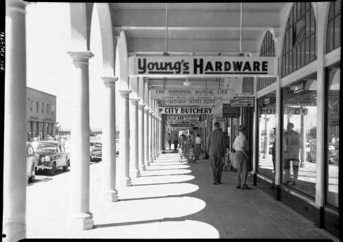 [Civic Centre shop signs, East Row, Canberra] [picture] / [Frank Hurley]