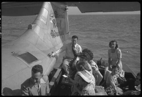 [Group of people on boat waiting to board Great Barrier Reef Airways flying boat] [picture] / [Frank Hurley]