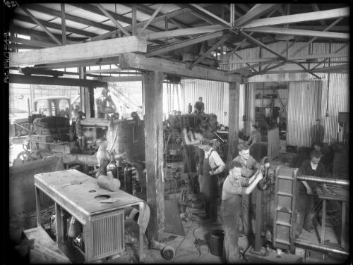Repairing earth moving equipment at Mt Beauty heavy  workshop [Kiewa, December 1947] [picture] : [State Electricity Commission of Victoria] / [Frank Hurley]