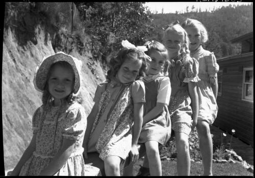 Bogong School [five girls playing on a see-saw, Kiewa, Victoria, December 1947] [picture] : [State Electricity Commission of Victoria] / [Frank Hurley]