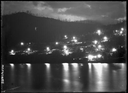 [A town at night, with lights reflected in a lake, Lake Guy? Kiewa, Victoria, December 1947?] [picture] : [State Electricity Commission of Victoria] / [Frank Hurley]