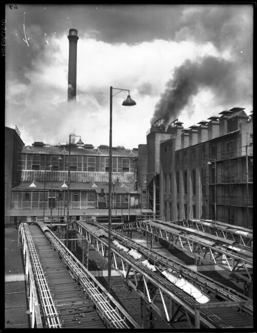 BF with launders in fg, vertical [Briquette Factory, Yallourn, Victoria, December 1947] [picture] : [State Electricity Commission of Victoria] / [Frank Hurley]