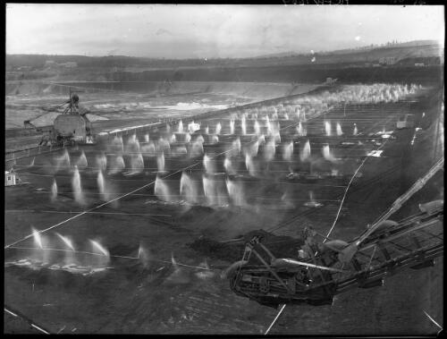 Spray on 2nd level [open cut coal mine, Yallourn, Victoria, December 1947] [picture] : [State Electricity Commission of Victoria] / [Frank Hurley]