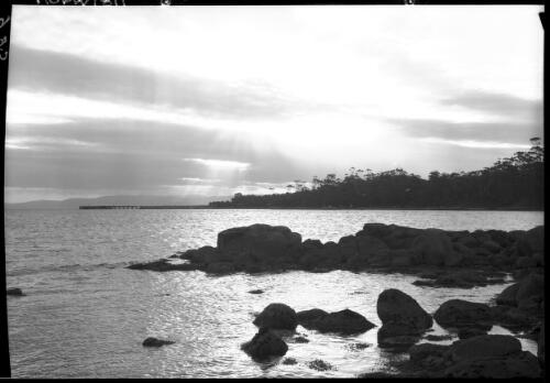 Sunset [with a rocky shoreline] [picture] : [Coles Bay, Tasmania] / [Frank Hurley]
