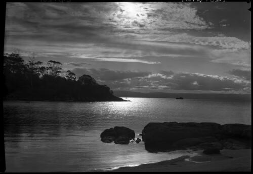 Sunset across Coles Bay [with boat in background] [picture] : [Coles Bay, Tasmania] / [Frank Hurley]