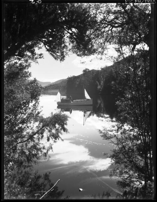Vista through trees with boat, similar to G3 [with two figures] [picture] : [Gordon River, Tasmania] / [Frank Hurley]