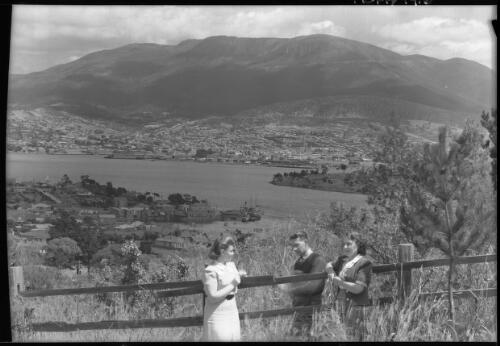 Waterfront with yachts [Hobart from Bellerive with three figures] [picture] : [Hobart, Tasmania] / [Frank Hurley]