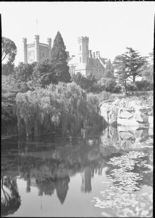 [Government House, with a clock tower, a turret and a lily pond] [picture] : [Hobart, Tasmania] / [Frank Hurley]