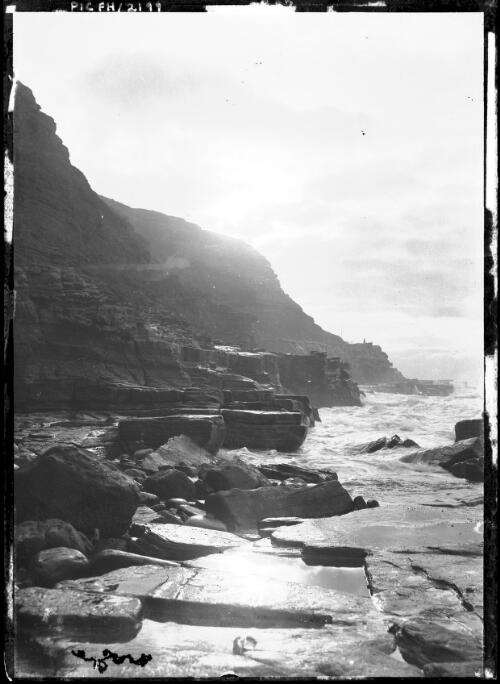 [Headlands and sea with foreground rocks] [picture] : [Tasmania] / [Frank Hurley]