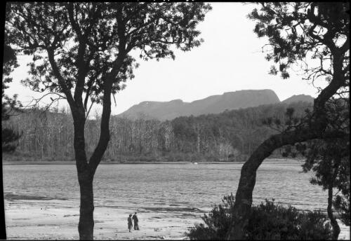 Mt Olympus & Lake St Clair [with two figures on shore] [picture] : [Lake St Clair, Tasmania] / [Frank Hurley]