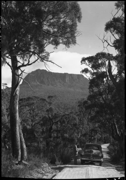 Ben Lomond Tas. [with car T1365 and figure] [picture] : [Ben Lomand, Tasmania] / [Frank Hurley]
