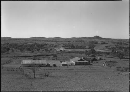 [Modern homestead on the Hastings Deering property at Palmer valley showing a caterpillar truck engaged in the excavation of a large storage dam] [picture] : [Central Australia] / [Frank Hurley]