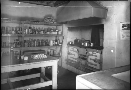 Accommodation Glen Helen [interior showing the kitchen with a large wood stove] [picture] : [Central Australia] / [Frank Hurley]
