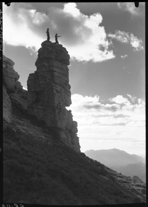 Sentinal Rock [with two figures on top of rock, near Frenchman's Cap] [picture] : [Frenchman Range, Tasmania] / [Frank Hurley]