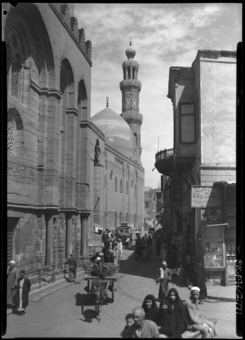The Mosque Barquq Cairo [with street, figures, a donkey and cart, a truck or bus] [picture] : [Cairo, Egypt, World War II] / [Frank Hurley]