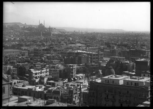 Courtyard, Sultan Hassan Citadel [Cairo rooftops with Citadel and hills on left] [picture] : [Cairo, Egypt panoramas] / [Frank Hurley]