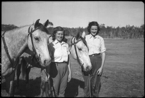 [Unidentified women standing side by side with horses, 1] [picture] / [Frank Hurley]