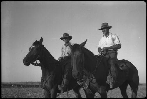 [Two men riding side by side on horses] [picture] / [Frank Hurley]