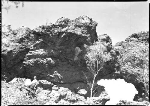 [Mountain scene with unidentified man resting on rock] [picture] / [Frank Hurley]