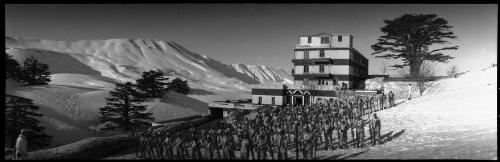 [Cedars of Lebanon, men standing to attention in rows, lodge behind] [picture] : [Lebanon, World War II] / [Frank Hurley]