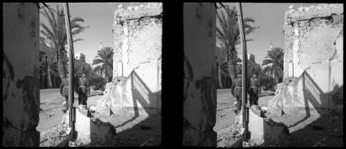 Various shots in Benghazi, scenes in Benghazi Cathedral  [two Allied officers walk through bombed street] [picture] : [Libya, World War II] / [Frank Hurley]