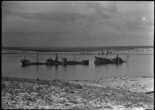WWII Tobruk [sunken ships, harbour] [picture] : [Libya, World War II] / [Frank Hurley]