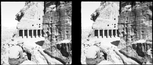 [Petra, Temple of the Urn from front left side, man sitting in foreground] [picture] : [Jordan, World War II] / [Frank Hurley]