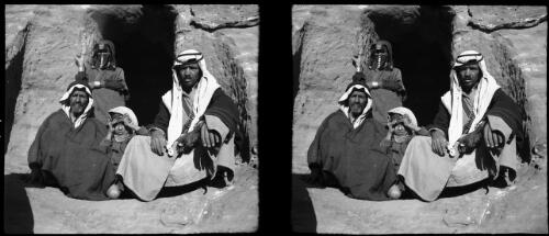 [Bedouin group, two men and a child foreground, woman behind, Petra] [picture] : [Jordan, World War II] / [Frank Hurley]