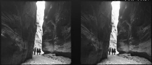 The Siq, the way into Petra valley [three men on donkeys, two with Arab head-dress] [picture] : [Jordan, World War II] / [Frank Hurley]