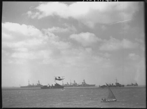 [Five Allied battleships, military flying boat, and felucca in foreground, harbour scene, some ships moored] [picture] : [Middle East, World War II] / [Frank Hurley]