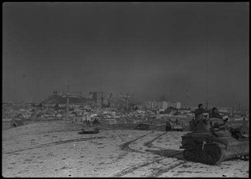 Aleppo [allied personnel carriers and light tanks advancing from town] [picture] : [Syria, World War II] / [Frank Hurley]