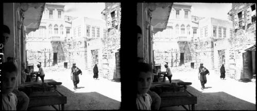 Crusader town? [courtyard or street, figures, stone buildings, scales] [picture] / [Frank Hurley]