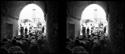 Hama is in Central Syria, a Moslem stronghold [sheep being herded through an arched stone tunnel, figures, buildings, minaret or tower] [picture] : [Syria, World War II] / [Frank Hurley]