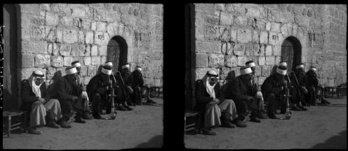 Group of blind men outside the Mosque Dome of the Rock,  Jerusalem [picture] / [Frank Hurley]