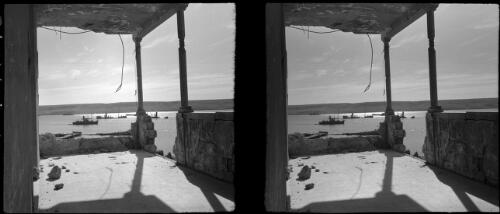 Various scenes taken in Tobruck Nov 28 42 [1942, view from a balcony with crumbling stone walls and ceilings, harbour with boats in the distance] [picture] : [Libya, World War II] / [Frank Hurley]