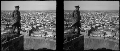 Aleppo [figure in military uniform, looking out over town] [picture] : [Syria, World War II] / [Frank Hurley]