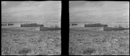 Tobruck Harbour [two large boats close to shore] [picture] : [Libya, World War II] / [Frank Hurley]