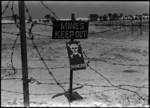 [Barbed wire around mine field with Keep Out and Danger signs] [picture] / [Frank Hurley]