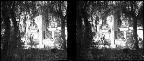 Senussi [Sanusi] training centre at Oberdan Cyrenaica [looking through the tree foliage] [picture] : [Libya, World War II] / [Frank Hurley]
