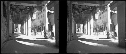 Scenes Benghazi harbour & town (also restored Town Hall now Administrative Centre) [looking down colonnade, partly in ruins] [picture] : [Libya, World War II] / [Frank Hurley]