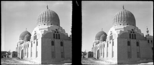 Scenes among the Mausolea of the Dead City of Eastern Cemetery Cairo, also called The Tombs of the Khalifes, shows the fine "Chevron" decorated twin domes of Barquqs mausoleum [picture] : [Egypt, World War II] / [Frank Hurley]