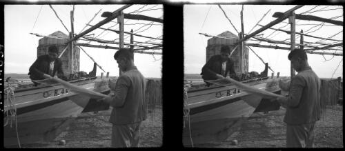 Rouad Isld. [two men and a boat working on a net] [picture] : [Syria, World War II] / [Frank Hurley]