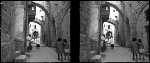 Scenes in Via Dolorosa [two children at the right] [picture] : [Middle East, World War II] / [Frank Hurley]
