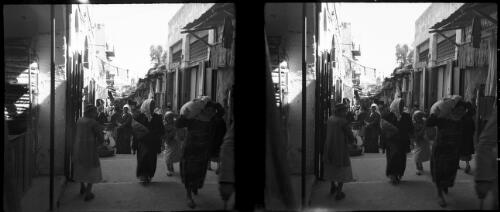 [Street shots, Amman, including a woman with a sack on her shoulders] [picture] : [Jordan, World War II] / [Frank Hurley]