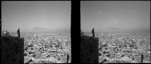 Jerusalem [overlooking the city, a man in military uniform standing on a stone wall] [picture] / [Frank Hurley]