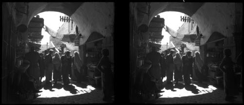 Jerusalem [men and women walking through an alleyway] [picture] / [Frank Hurley]